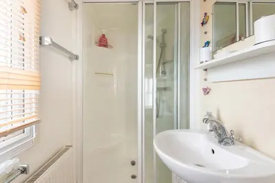 a bathroom with a sink and a shower at Sunshine Retreat Wadebridge in Wadebridge