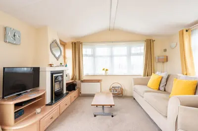 a living room with a couch and a tv at Sunshine Retreat Wadebridge in Wadebridge