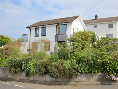 a white house with plants in front of it at Cormorants Polruan village sea coastline views in Fowey