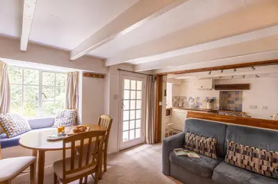 a living room with a couch and a table at Cuckoo Tor Lanteglos woodland coastline nearby in Lanteglos