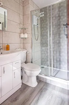a bathroom with a toilet sink and a shower at Rowan Cottage - sleeps 2 - Nr Looe and Polperro in Lanreath