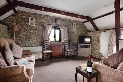 a living room with two couches and a television at Rowan Cottage - sleeps 2 - Nr Looe and Polperro in Lanreath