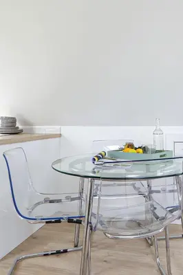 a glass table with two chairs and a plate on top at The Loft in Wadebridge