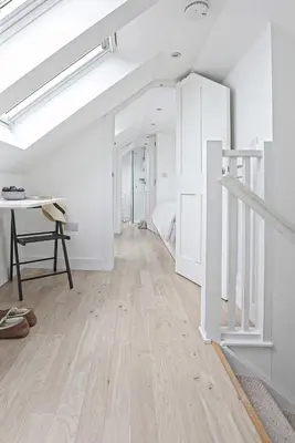 a room with white walls and a wooden floor at The Loft in Wadebridge
