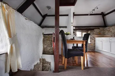 a room with a table and a dining room at Rowan Retreat - sleeps 2 - Nr Looe and Polperro in Lanreath