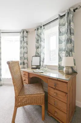 a home office with a desk and a chair at Trotters barn conversion on edge of Mount Hawke in Mount Hawke