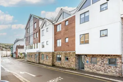 an empty street with a white building at Zephyr in Fowey