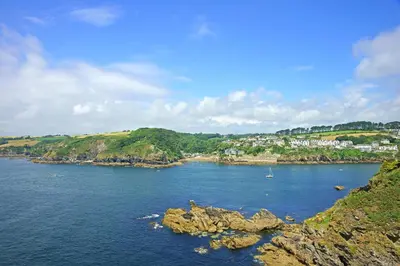 a large body of water with a town in the background at Zephyr in Fowey