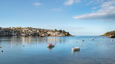 two boats in a large body of water at Well Court is a fabulous cottage with wonderful views set in the heart of Polruan village in Fowey