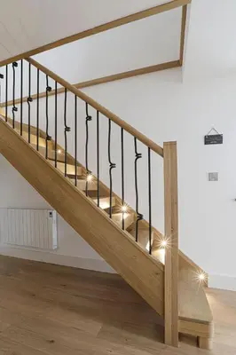 a wooden staircase in a room with lights on it at Trekenna close to Marazion and Praa Sands in Saint Hilary