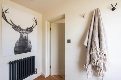 a room with a picture of a deer on the wall at Longstone at Bogee Farm in Saint Ervan