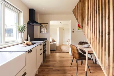 a kitchen with a table and a dining room at Longstone at Bogee Farm in Saint Ervan