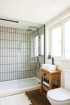 a bathroom with a shower and a toilet and a sink at Longstone at Bogee Farm in Saint Ervan
