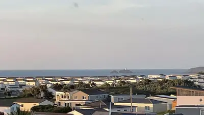 a group of houses in front of the ocean at E42 Vista Marina, Riviere Towans in Hayle