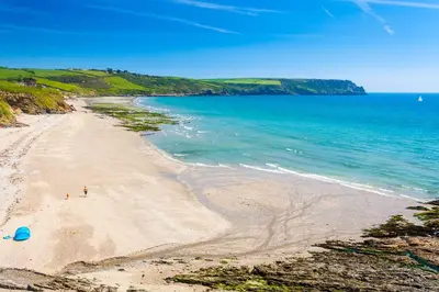 a beach with people on the sand and the ocean at Trewhiddle Cottage 41 - 1 Bed Ensuite in St Austell