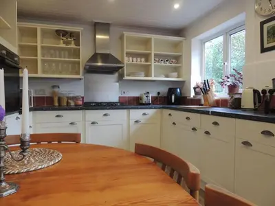 a kitchen with a wooden table and a dining room at Oxencombe in Davidstow