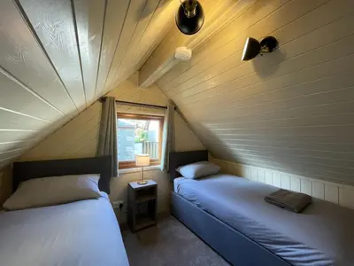 two beds in a small room with a window at RoseTree Lodge 3 bed Sleeps 6 in Michaelstow