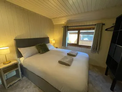 a bedroom with a large bed with two towels on it at RoseTree Lodge 3 bed Sleeps 6 in Michaelstow