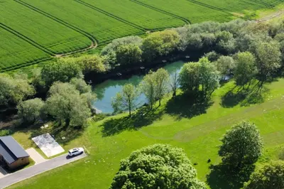 an aerial view of a lake in a field at RoseTree Lodge 3 bed Sleeps 6 in Michaelstow