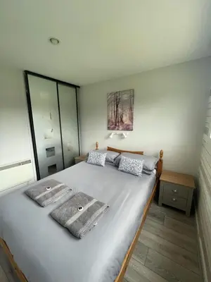 a bedroom with a large bed with two towels on it at Villa 19 Lanteglos 2 bed sleep 5 in Lanteglos