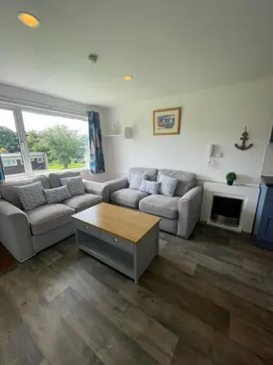 a living room with two couches and a coffee table at Villa 19 Lanteglos 2 bed sleep 5 in Lanteglos