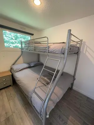 a bedroom with two bunk beds and a window at Villa 19 Lanteglos 2 bed sleep 5 in Lanteglos