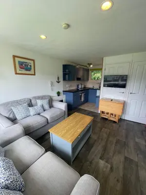 a living room with a couch and a table at Villa 19 Lanteglos 2 bed sleep 5 in Lanteglos