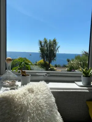 a window with a view of the ocean at Stunning Sea View Apartment in Falmouth