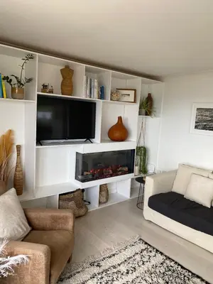 a living room with a tv and a fireplace at Stunning Sea View Apartment in Falmouth