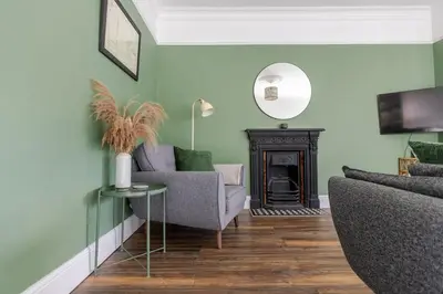 a living room with a couch and a fireplace at Stylish 3-Bed Home - 2 Mins to Beach & Town in Falmouth