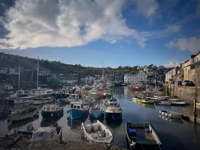 a bunch of boats are docked in a harbor at Chapel Cottage in St Austell