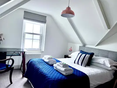 a bedroom with a bed with towels on it at Fimbarr's Reach in Fowey