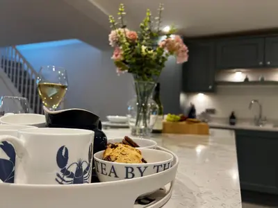 a table with a bowl of food and a glass of wine at Fimbarr's Reach in Fowey