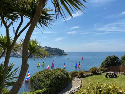 a group of people on the water with sailboats at Fimbarr's Reach in Fowey