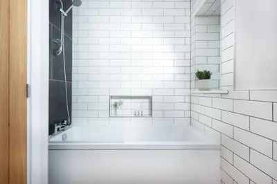 a white bathroom with a tub and a shower at Little Beachside in Newquay