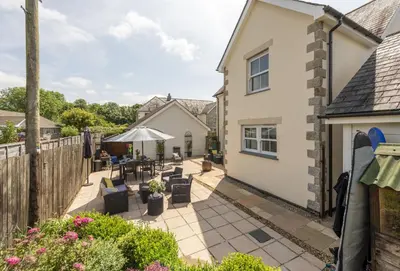 a garden with a patio and a house at Little Puffin Way in Hayle