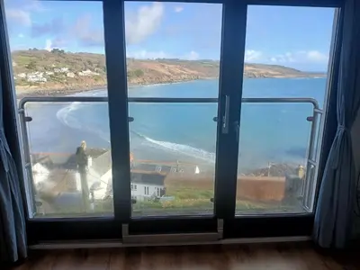 a window with a view of a body of water at Harbour Views, Coverack in Helston