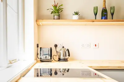 a kitchen with a toaster on a kitchen counter at Romantic and stylish retreat in Falmouth