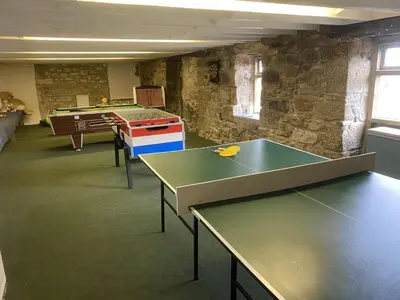 a room with ping pong tables and a ping pong table at The Little Barn Near St Ives Beaches & Walks, Dog Friendly in St Ives