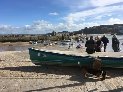 a group of people and a dog standing next to a boat at The Little Barn Near St Ives Beaches & Walks, Dog Friendly in St Ives