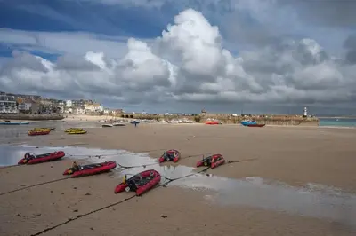 a beach with three kayaks on the sand at The Little Barn Near St Ives Beaches & Walks, Dog Friendly in St Ives