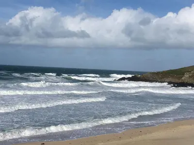 a beach with waves in the ocean with at The Little Barn Near St Ives Beaches & Walks, Dog Friendly in St Ives