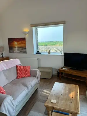 a living room with a couch and a coffee table at The Little Barn Near St Ives Beaches & Walks, Dog Friendly in St Ives