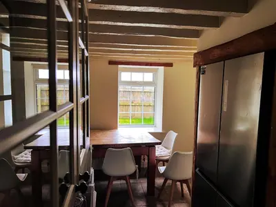 a dining room with a table and chairs and a window at Countryside Converted Barn and Cottages Near Newquay in Saint Enoder
