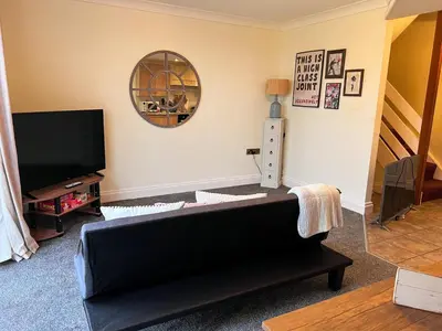 a living room with a couch and a mirror at Countryside Converted Barn and Cottages Near Newquay in Saint Enoder