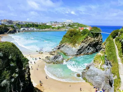 a group of people on a beach near the ocean at Countryside Converted Barn and Cottages Near Newquay in Saint Enoder