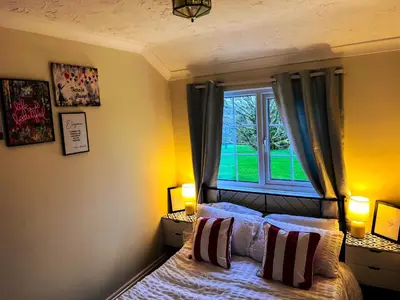 a bedroom with a bed and a window at Countryside Converted Barn and Cottages Near Newquay in Saint Enoder
