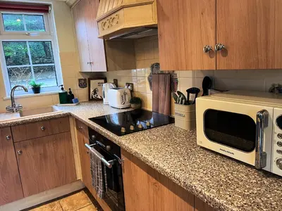a kitchen with a counter top with a microwave at Countryside Converted Barn and Cottages Near Newquay in Saint Enoder