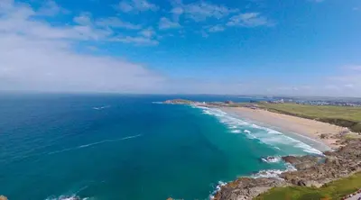 an aerial view of the ocean and a beach at Countryside Converted Barn and Cottages Near Newquay in Saint Enoder