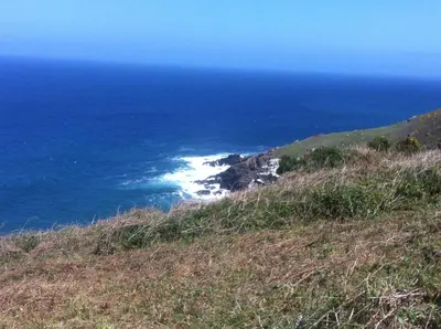 a view of the ocean from the top of a hill at The Stable Near St Ives Beaches Dog Friendly in St Ives